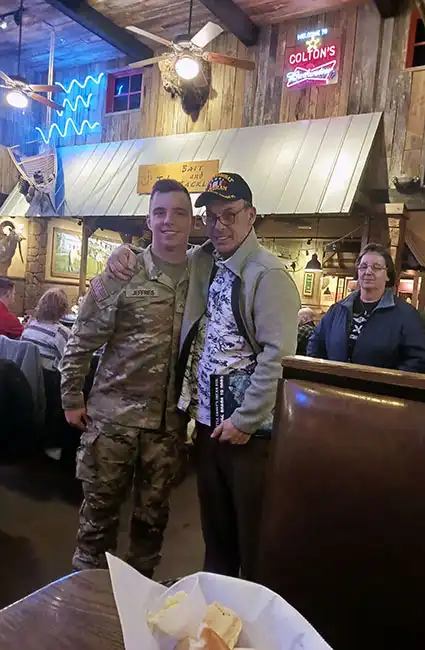 Graduating Soldier with Veteran David Haave, proud mom looking on.